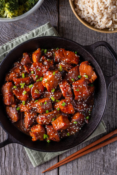 Sesame Chicken Sesame Chicken in a Wok with Rice and Broccoli sesame photos stock pictures, royalty-free photos & images