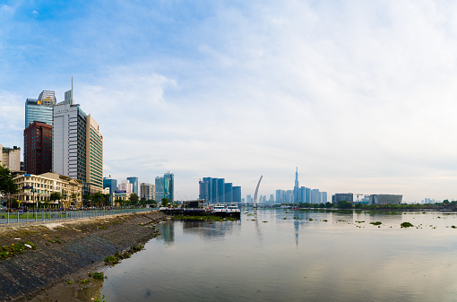 Ho Chi Minh city, Vietnam - FEB 12 2022: skyline with landmark 81 skyscraper, a new cable-stayed bridge is building connecting Thu Thiem peninsula and District 1 across the Saigon River.