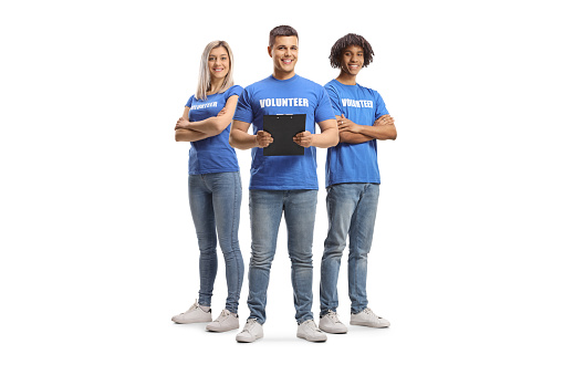 Group of volunteers in blue t-shirts isolated on white background