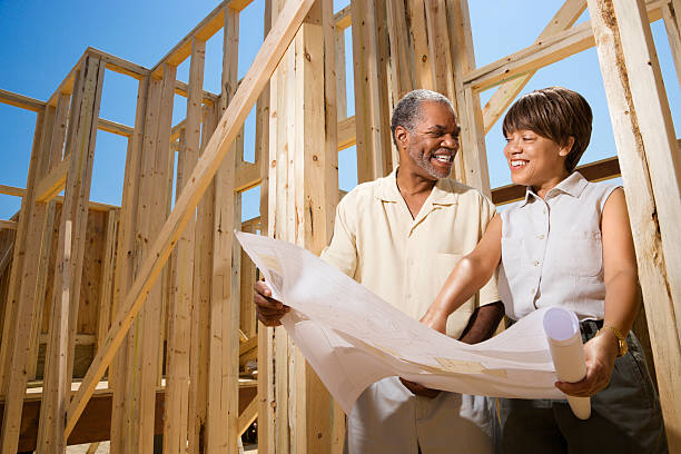istock Couple holding blueprints at construction site 146775388