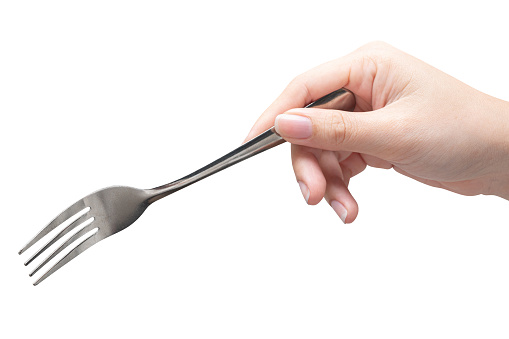 isolated of a woman's hand holding a silver fork to pick food.