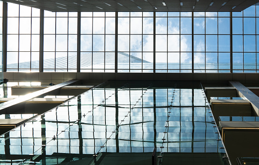 Modern building structure, see through roof with sky view.