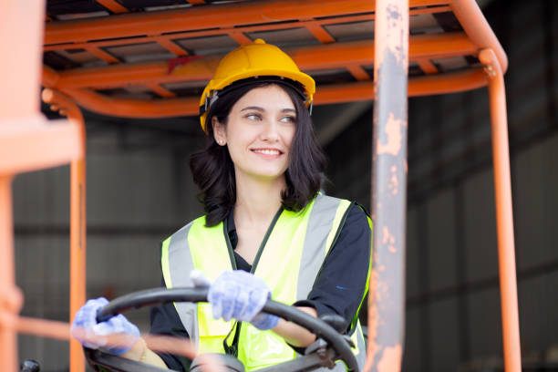 istock Young asian woman is foreman driving forklift at distribution warehouse, engineer working and shipping container at factory, cargo and logistic, one person, industry and transport concept. 1467758664