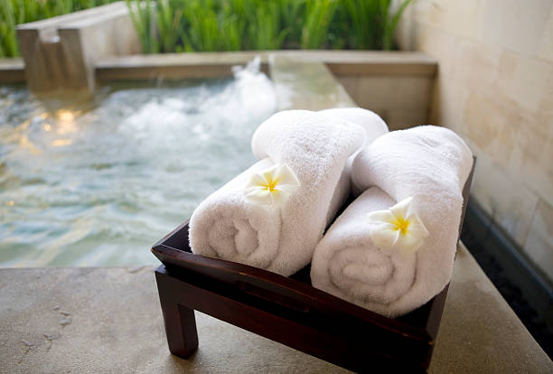 istock Towels and flowers with a hot tub behind 146776467