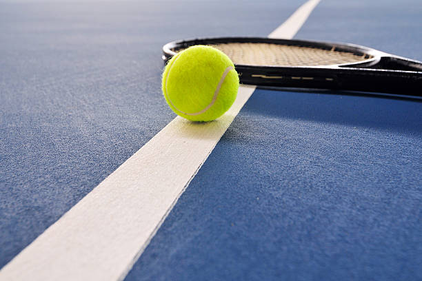Tennis ball  and racket just on the line