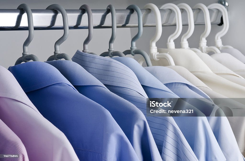 Man's wear- businessman shirts Office clothing- wardrobe with business shirts on hangers, formal clothing Dry Cleaned Stock Photo