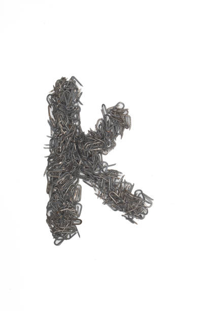 istock artistic isolated lowercase Letter K made from steel staples isolated on a white background write, font, type style 1467768697