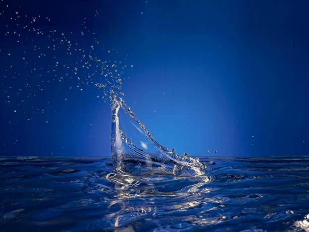 Close up of splashing water droplet. Blue Background