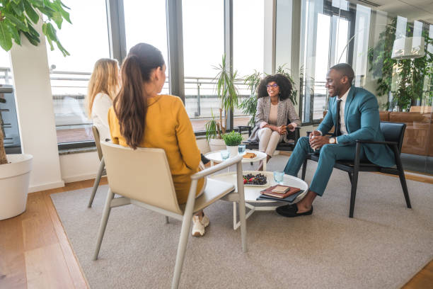 istock Black Man and Multiracial Women Talking at the Office 1467772243