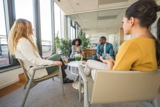 istock Black Man and Multiracial Women Talking at the Office 1467772301