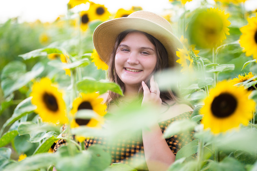 Cuban girl on sunflower field