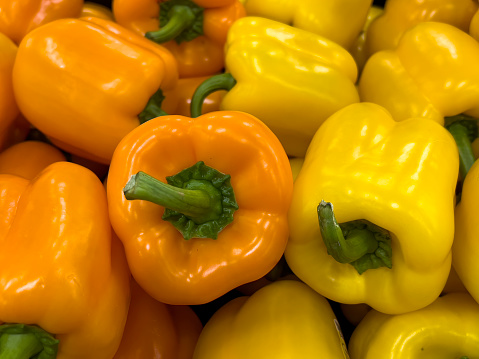 Close up of orange and yellow bell peppers.