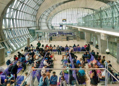 Bangkok, Thailand - July 21, 2022. Passengers waiting in an international departure gate at Suvarnabhumi Airport for their flight to Manila, Philippines.