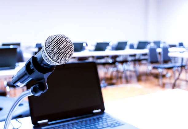 istock Close up microphone with laptop on table background in seminar room 1467774502