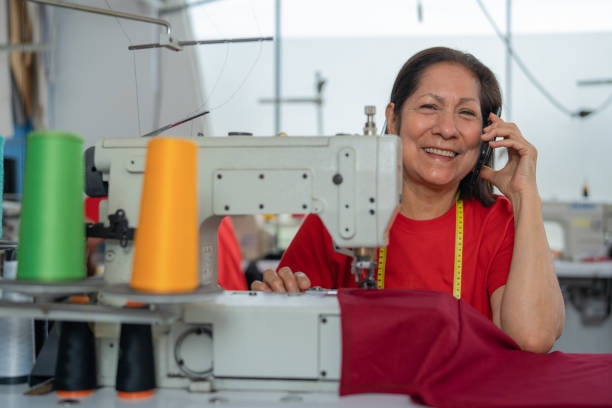 istock Happy woman talking to the mobile in a sewing workshop 1467775092