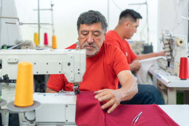 Worker sewing polypropylene bags with a sewing machine - Textile Industry - Buenos Aires - Argentina