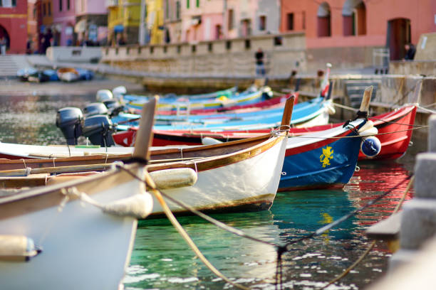 Colourful fishing boats in small marina of Vernazza, one of the five centuries-old villages of Cinque Terre, located on rugged northwest coast of Italian Riviera. stock photo
