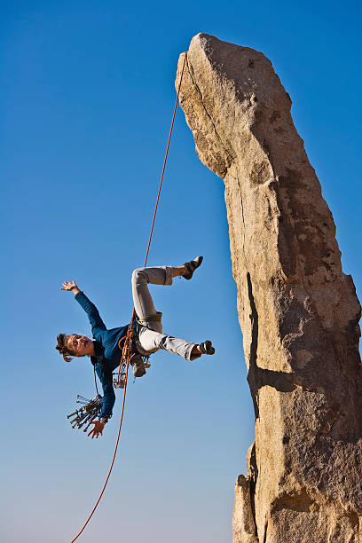 Female rock climber falling. stock photo