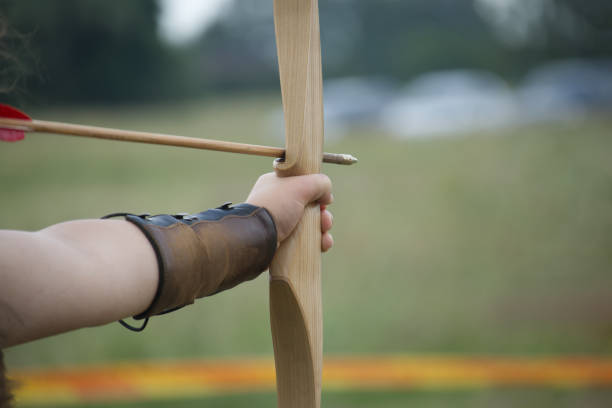 istock Archer hand holding wooden bow and arrow 1467782355
