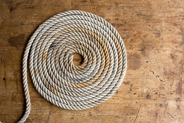 Coiled marine anchor line on an antique chest stock photo