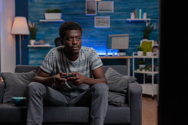 istock African american man using console playing virtual video games on television 1467790516