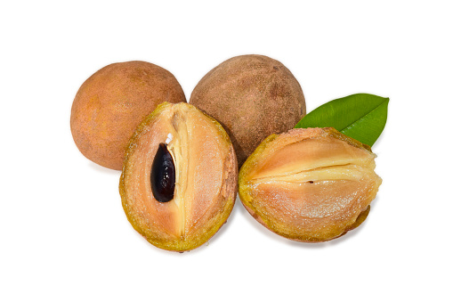 Slice of sapodilla, Chickoo fruit with leaves isolated on white background