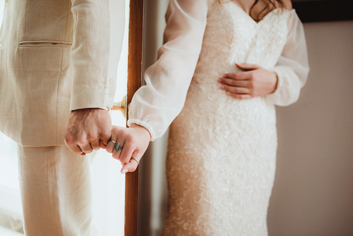 Bride and groom hold hands before their wedding ceremony