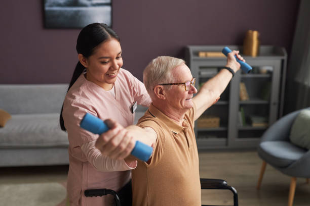 istock Social worker helping senior man to exercise 1467798389