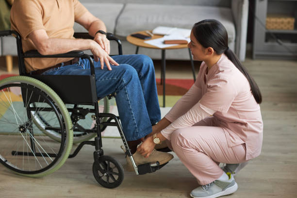 istock Social worker tying a shoelace to man with disability 1467798394