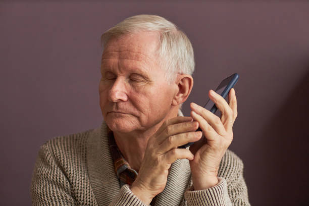 istock Blind man listening to audio assistant on smartphone 1467798429