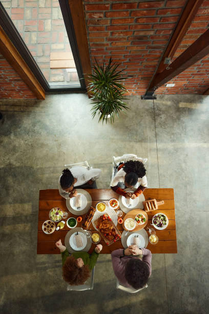 istock Above view of young couples having lunch at dining table. 1467799998