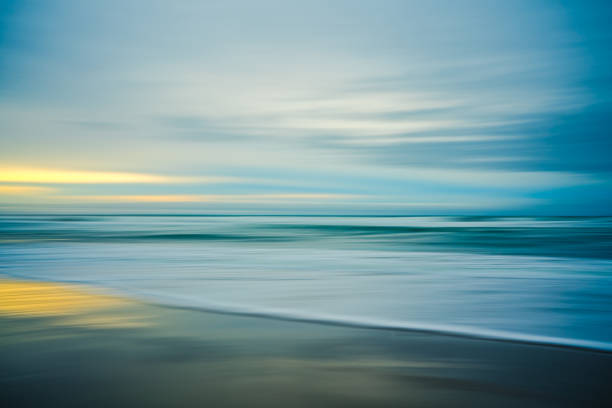 istock Sunset on the beach, abstract. Motion blur abstract seascape in light turquoise and yellow colors 1467800573