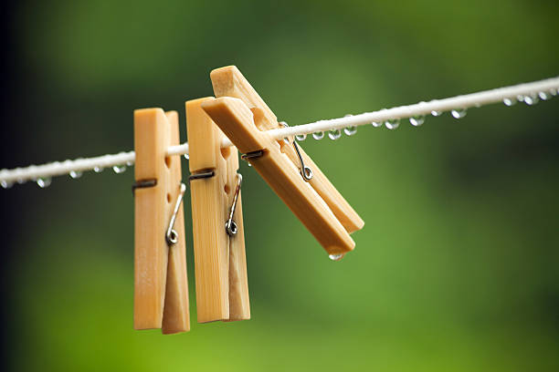 Close-up of clothespins on a rope with a patterned background