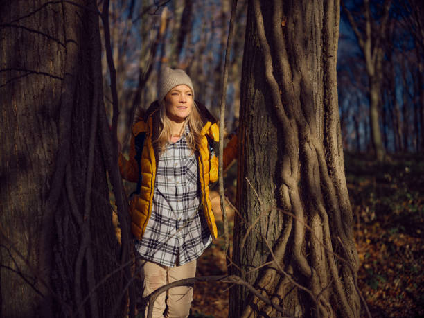 istock Smiling female backpacker having a break among trees in nature. 1467801377