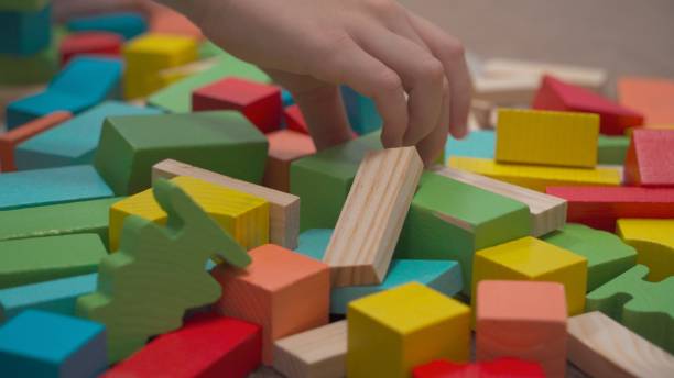 istock Close-up of a child's hand in the frame selects in turn certain cubes 1467802237