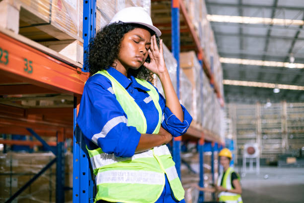 istock Industrial warehouse worker having problems at work. Female employee having headache at big job. 1467802814