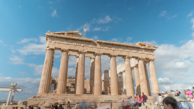 Time lapse low angle wide shot view of the Parthenon with clouds moving overhead / daytime Athens, Greece