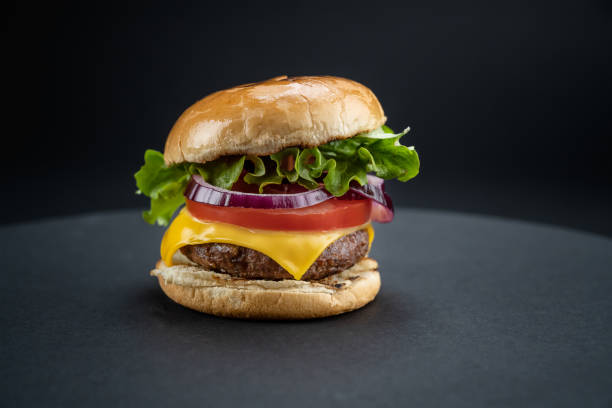 istock Homemade beef burger with fresh ingredients on black 1467805187