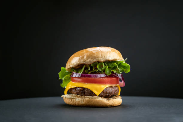 istock Homemade beef burger with fresh ingredients on black 1467805302