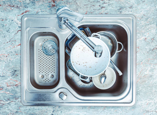 dishwashing - pile of dirty dishes in kitchen sink - sink domestic kitchen kitchen sink faucet imagens e fotografias de stock