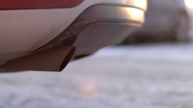 Close-up of muffler during car exhaust emissions.