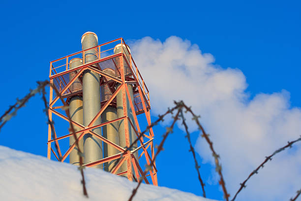 Smoking pipes Smoking pipes with the blue sky on the background barbed wire wire factory sky stock pictures, royalty-free photos & images