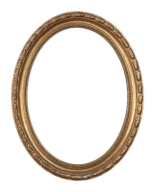An ancient, golden, oval inlayed wooden frame.