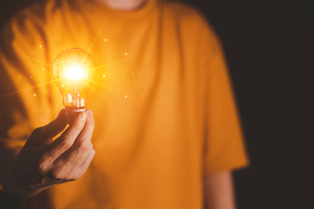 istock Businessman hand hold Virtual lightbulb. New ideas inspiration and innovation technology concept. Science and communication concept. 1467815038