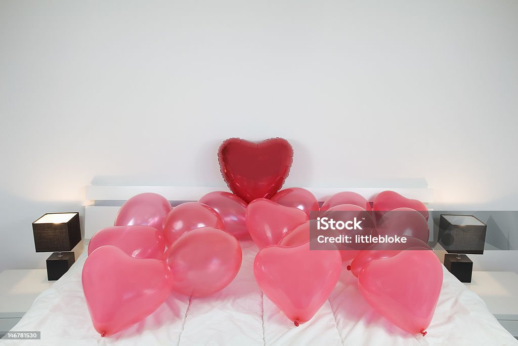 Red Love heart Shaped balloons Red Love heart Shaped balloons on A King Size bed Balloon Stock Photo