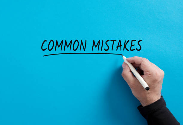 istock Male hand underlines the word Common Mistakes on blue background. 1467816055
