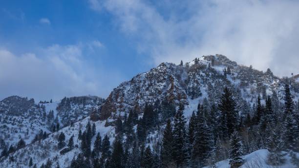 istock a man snowboards down a snowy mountain in a snowy valley 1467816169