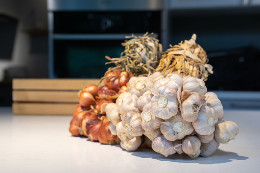 Garlic and Shallot Bundle in studio light on the white marble surface table