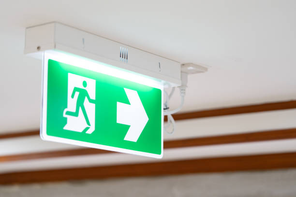 istock A Arrow light box sign of EMERGENCY FIRE EXIT is hung on the ceiling in hospital walkway, Idea for event fire or evacuation drills. 1467817399