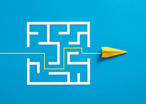 istock Paper plane breaking through the maze on blue background. 1467817513